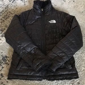 Girls black reversible The North Face coat.